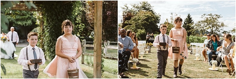 Premier snohomish & seattle wedding photographer | gsquared weddings photography two children a boy in suspenders and a girl in a pink dress walk down the aisle at a snohomish wedding ceremony each carrying a small basket Guests are seated on either side with lush greenery surrounding this charming seattle celebration | serving snohomish seattle                   & beyond