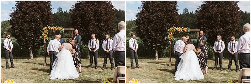 Premier snohomish & seattle wedding photographer | gsquared weddings photography a bride in a white dress stands outdoors with a woman facing a groom and groomsmen in dress shirts and ties near a floral arch and green trees under a partly cloudy sky at this romantic snohomish seattle wedding | serving snohomish seattle                   & beyond