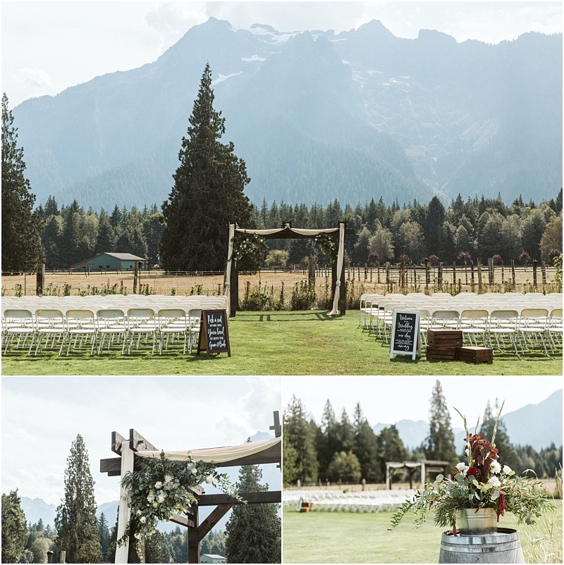 Premier snohomish & seattle wedding photographer | gsquared weddings photography an outdoor snohomish wedding ceremony setup on a lawn with white chairs facing a wooden arch decorated with greenery set against a scenic backdrop of mountains tall pine trees and clear skyperfect for a seattle engagement celebration | serving snohomish seattle                   & beyond