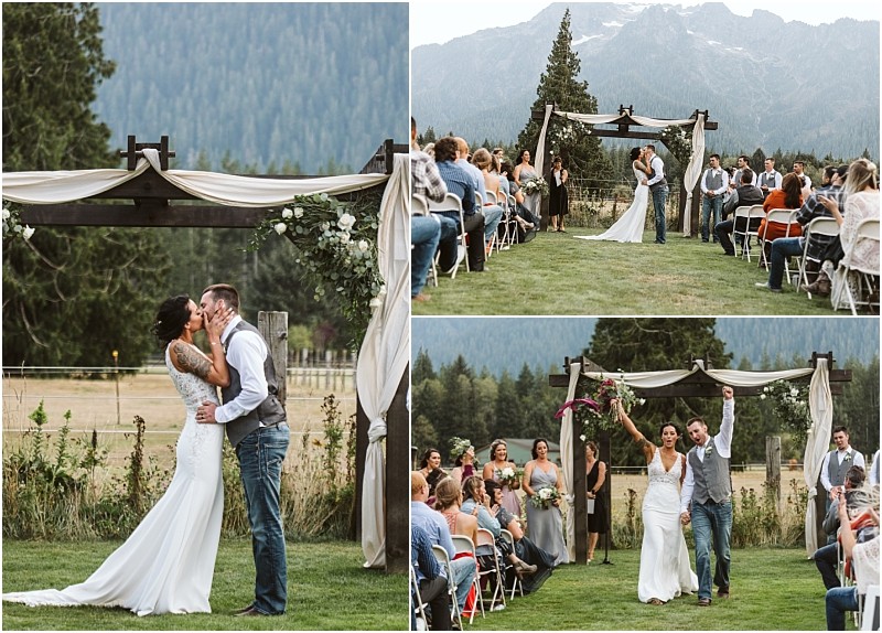 Premier snohomish & seattle wedding photographer | gsquared weddings photography a bride and groom kiss and celebrate during a romantic snohomish wedding ceremony with guests on either side and mountains in the background The couple walks joyfully down the aisle under an arbor with white drapes | serving snohomish seattle                   & beyond