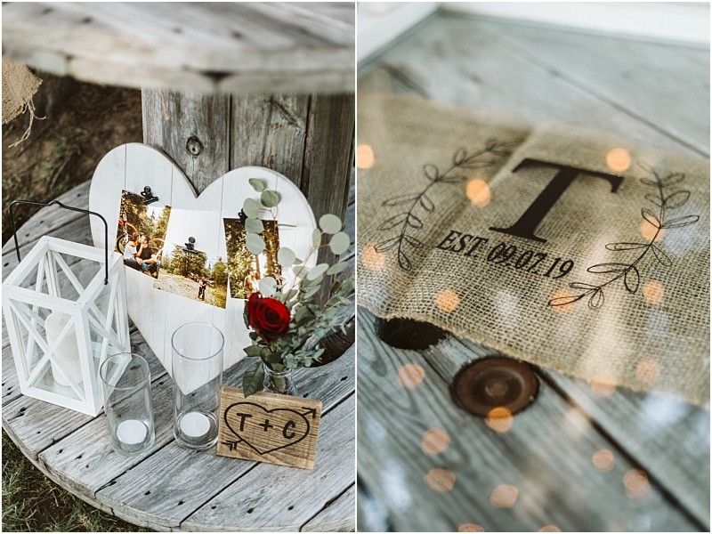 Premier snohomish & seattle wedding photographer | gsquared weddings photography a rustic snohomish wedding decor display features a wooden spool table with a heart shaped photo frame white lantern glass vases a red rose and a burlap sign with t est 10 19 surrounded by leaves and fairy lights | serving snohomish seattle                   & beyond