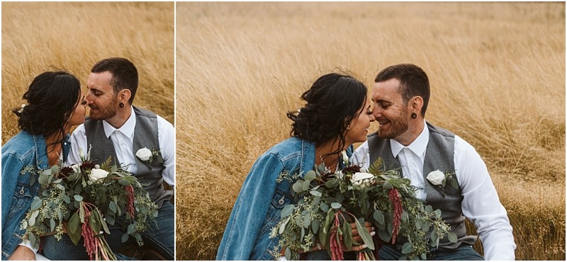 Premier snohomish & seattle wedding photographer | gsquared weddings photography a couple sits closely together in a golden grassy field near snohomish smiling at each other The woman holds a bouquet of greenery and white flowers wearing a denim jacketperfect for their seattle wedding engagement session | serving snohomish seattle                   & beyond