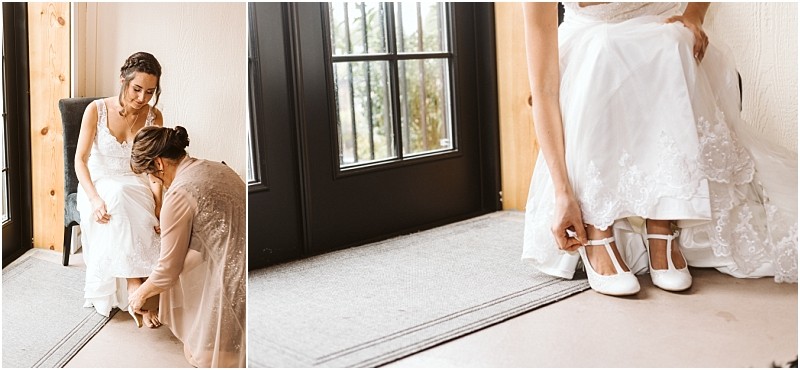 Premier snohomish & seattle wedding photographer | gsquared weddings photography a bride in a white dress sits indoors in snohomish while another woman helps her adjust her shoes The brides lace dress and white heels are visible as she prepares for her seattle wedding with natural light streaming through a nearby glass door | serving snohomish seattle                   & beyond