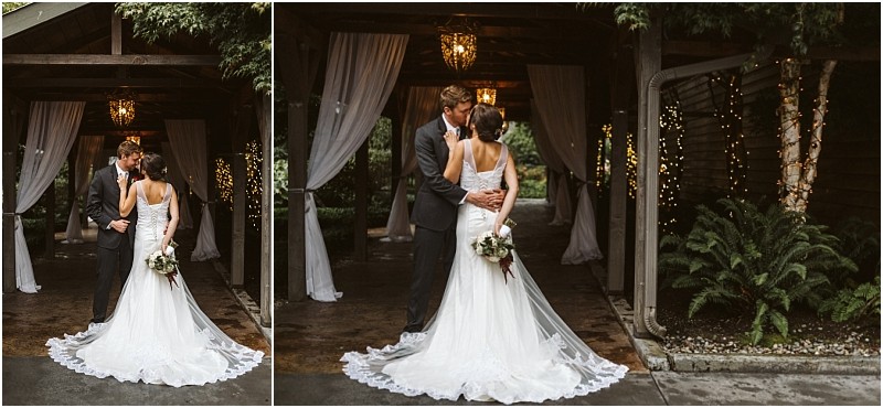 Premier snohomish & seattle wedding photographer | gsquared weddings photography a bride and groom stand close together under a wooden pergola draped with white curtains and string lights at their charming snohomish wedding The bride holds a bouquet the groom wears a dark suit and lush greenery surrounds this romantic seattle engagement | serving snohomish seattle                   & beyond