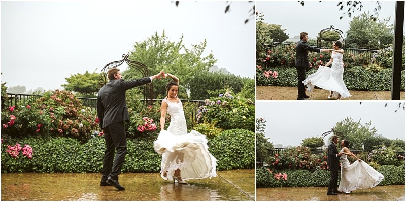 Premier snohomish & seattle wedding photographer | gsquared weddings photography a bride and groom dance joyfully in the rain on a stone patio surrounded by lush greenery and colorful flowersan unforgettable snohomish seattle wedding moment as the brides white dress swirls while they twirl together | serving snohomish seattle                   & beyond