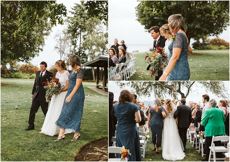 Premier snohomish & seattle wedding photographer | gsquared weddings photography a bride in a white dress walks down an outdoor aisle at a scenic snohomish seattle wedding accompanied by two people Guests seated on white chairs watch and smile amid lush trees and green grass | serving snohomish seattle                   & beyond
