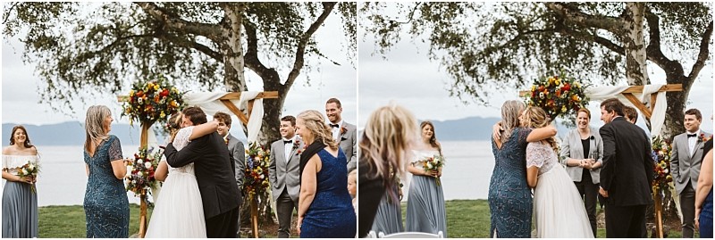 Premier snohomish & seattle wedding photographer | gsquared weddings photography two side by side photos of a snohomish outdoor wedding show a bride hugging a woman in a blue dress then standing with a man in a suit beside an officiant under a floral archway near a lake with smiling wedding party members nearby | serving snohomish seattle                   & beyond