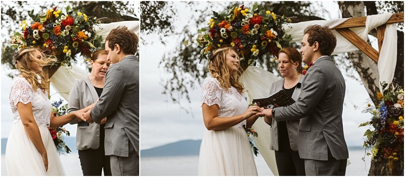 Premier snohomish & seattle wedding photographer | gsquared weddings photography a bride and groom stand under a floral arch outdoors in snohomish holding hands and exchanging vows with an officiant while mountains and water appear in the backgrounda stunning seattle wedding moment | serving snohomish seattle                   & beyond