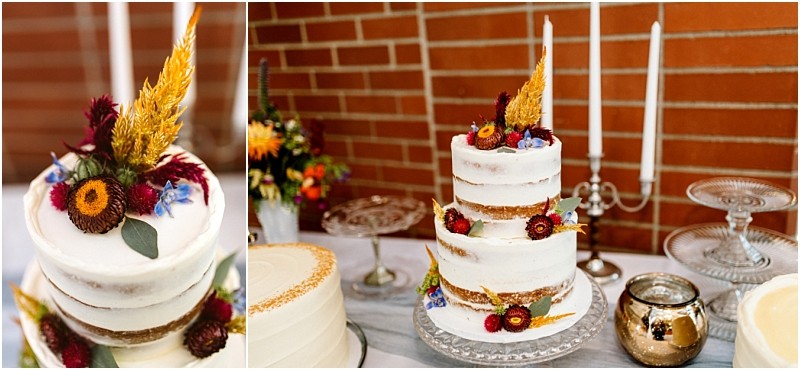 Premier snohomish & seattle wedding photographer | gsquared weddings photography a three tiered semi naked cake decorated with dried flowers and grasses sits on a glass stand surrounded by candles and floral arrangementsperfect for a snohomish or seattle wedding or engagement celebration against a rustic brick wall | serving snohomish seattle                   & beyond