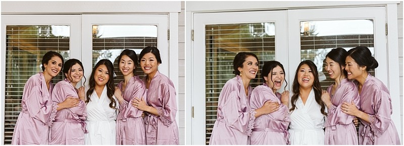 Premier snohomish & seattle wedding photographer | gsquared weddings photography five women in matching robes four in lilac and one in white stand closely together smiling and laughingcapturing a joyful moment before a snohomish seattle wedding or engagementin front of glass doors with white frames | serving snohomish seattle                   & beyond