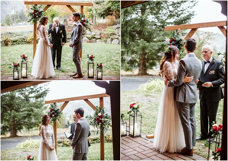 Premier snohomish & seattle wedding photographer | gsquared weddings photography a bride and groom stand together under a wooden arch decorated with flowers during their outdoor snohomish wedding ceremony A man officiates as they exchange vows surrounded by greenery and candle lanterns | serving snohomish seattle                   & beyond