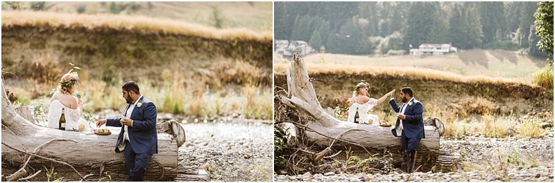 Premier snohomish & seattle wedding photographer | gsquared weddings photography a couple dressed in wedding attire shares a picnic on a large fallen tree trunk in a scenic rustic outdoor settingperfect for a snohomish seattle wedding engagementwith grass rocks and distant trees | serving snohomish seattle                   & beyond