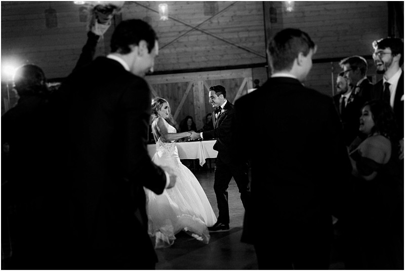 Premier snohomish & seattle wedding photographer | gsquared weddings photography a bride and groom dance together in the center of a dimly lit room surrounded by guests watching them This black and white photo captures a classic romantic atmosphere at their unforgettable snohomish seattle wedding | serving snohomish seattle                   & beyond