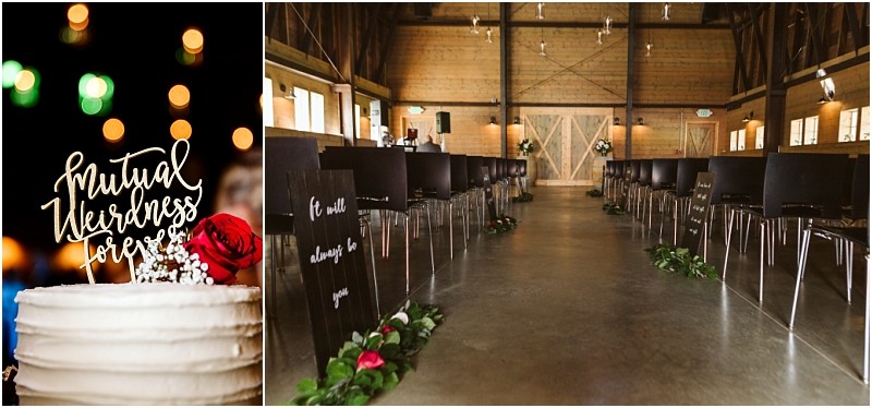 Premier snohomish & seattle wedding photographer | gsquared weddings photography a wedding cake with a mutual weirdness forever topper and a red rose sits beside an aisle decorated with greenery and signs at a rustic snohomish barn wedding venue near seattle featuring wooden walls and black chairs for an unforgettable engagement celebration | serving snohomish seattle                   & beyond