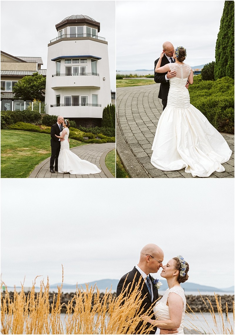 Premier snohomish & seattle wedding photographer | gsquared weddings photography a bride and groom dressed formally embrace and pose for photos outside a white lighthouse style building near snohomish on a curving walkway and by tall grass with water and mountains in the background | serving snohomish seattle                   & beyond
