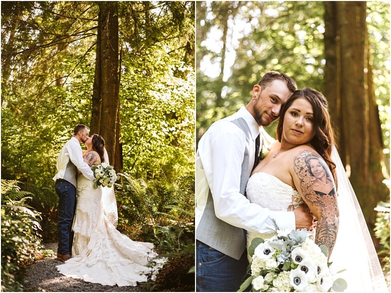 Snohomish & seattle wedding photographer | gsquared weddings photography one of the best of 2019 this wedding couple poses in a lush forest setting The bride wears a strapless lace gown and holds a bouquet while the groom in a vest and jeans stands happily with her among tall trees and greenery | wedding photo by gsquared weddings