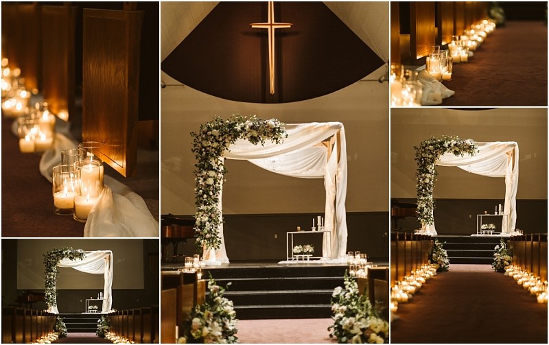 Snohomish & seattle wedding photographer | gsquared weddings photography a wedding altar with a draped white canopy and floral decorations stands on a stage The aisle lined with glowing candles in glass holders creates a warm romantic atmosphere for this beautiful marysville wedding inside a dimly lit church | wedding photo by gsquared weddings
