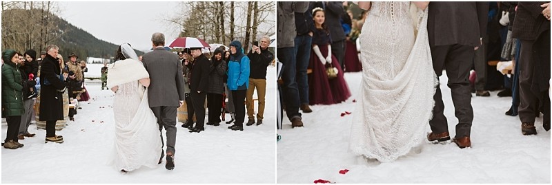 Snohomish & seattle wedding photographer | gsquared weddings photography a bride in a white gown walks on snowy ground arm in arm with an older man while wedding guests bundled in winter clothes look on and smile at this magical leavenworth wedding | wedding photo by gsquared weddings