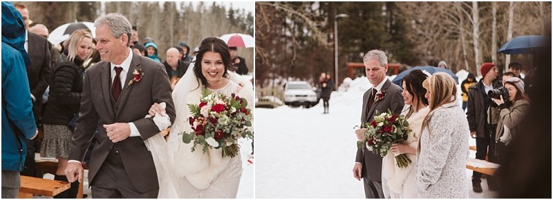 Snohomish & seattle wedding photographer | gsquared weddings photography a bride smiles as she walks outside in snowy weather at a leavenworth wedding holding a bouquet and linking arms with an older man in a suit Guests in winter clothing watch as a photographer captures the moment | wedding photo by gsquared weddings