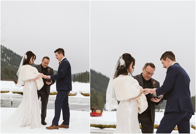 Snohomish & seattle wedding photographer | gsquared weddings photography a bride and groom exchange rings during an outdoor winter leavenworth wedding ceremony by a snowy lake with an officiant standing between them and trees in the background | wedding photo by gsquared weddings