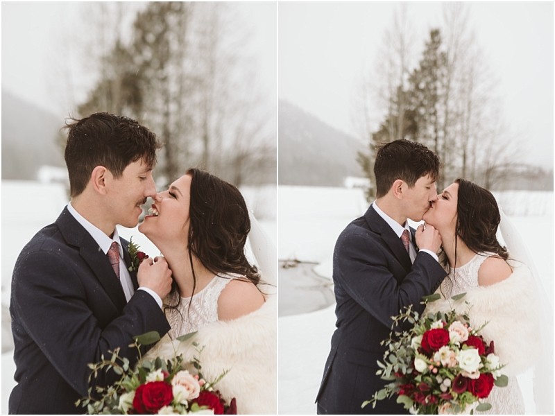 Snohomish & seattle wedding photographer | gsquared weddings photography a bride and groom in winter wedding attire share joyful affectionate moments outdoors Snow covers the ground as this leavenworth wedding couple holds a bouquet of red and white flowers smiling and kissing amid a snowy landscape with trees | wedding photo by gsquared weddings