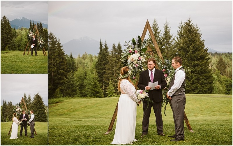 Snohomish & seattle wedding photographer | gsquared weddings photography three people stand outdoors at a machias elopement ceremony The couple faces each other with an officiant between them in front of a triangular floral archcelebrating love with a view of evergreen trees and mountains in the background | wedding photo by gsquared weddings