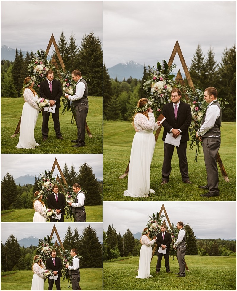 Snohomish & seattle wedding photographer | gsquared weddings photography a bride and groom stand with an officiant before a wooden triangular arch adorned with flowers during their machias elopement exchanging vows on a grassy field with trees and mountainstruly love with a view | wedding photo by gsquared weddings