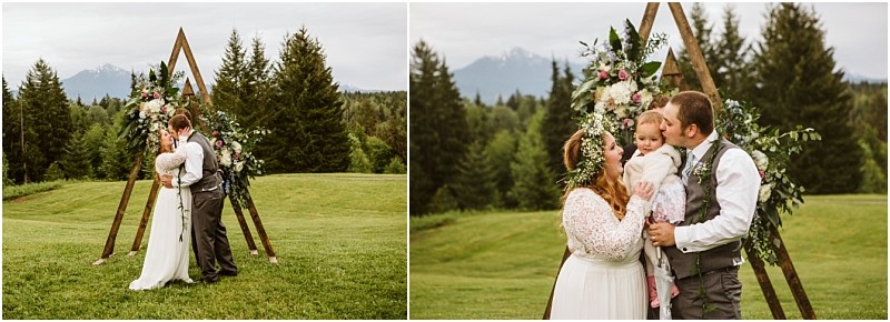 Snohomish & seattle wedding photographer | gsquared weddings photography a bride and groom share a kiss under a wooden triangle arch adorned with flowers In another photo they enjoy their machias elopement standing with their child and smiling against a lush mountain backdroplove with a view | wedding photo by gsquared weddings