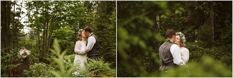Snohomish & seattle wedding photographer | gsquared weddings photography a bride and groom embrace and share a kiss in a lush green forest during their machias elopement Surrounded by ferns and trees they celebrate love with a viewthe bride in white with a flower crown bouquet resting on a tree stump nearby | wedding photo by gsquared weddings
