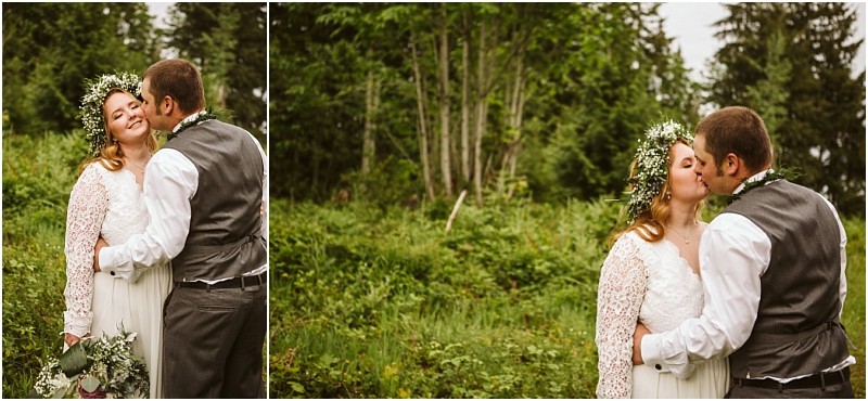 Snohomish & seattle wedding photographer | gsquared weddings photography a bride in a lace dress and flower crown smiles as her groom in a gray vest hugs and kisses her on the cheek during their machias elopement surrounded by lush green treespure love with a view | wedding photo by gsquared weddings