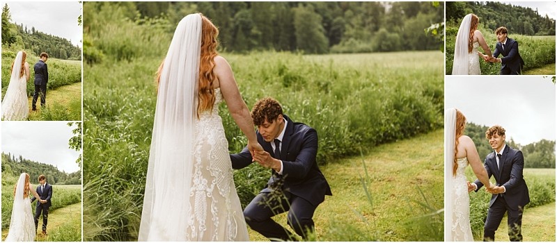 Snohomish & seattle wedding photographer | gsquared weddings photography a groom in a blue suit kneels in awe as he sees his bride dressed in a white lace gown and veil during their marionfield farm elopement first look in a lush green outdoor setting | wedding photo by gsquared weddings