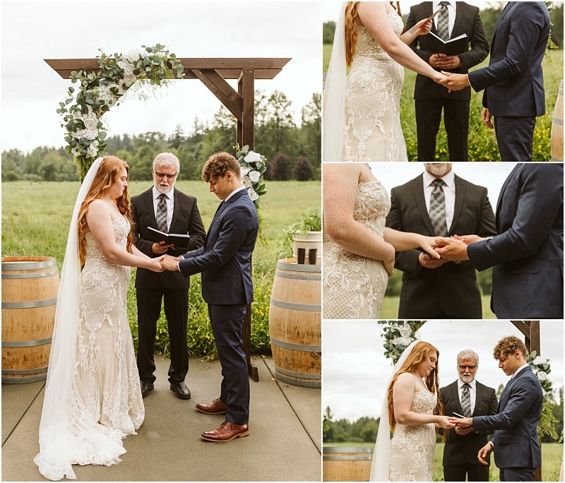 Snohomish & seattle wedding photographer | gsquared weddings photography a bride and groom stand under a wooden arch adorned with greenery and white flowers exchanging vows and holding hands during a marionfield farm elopement with an officiant standing behind them | wedding photo by gsquared weddings