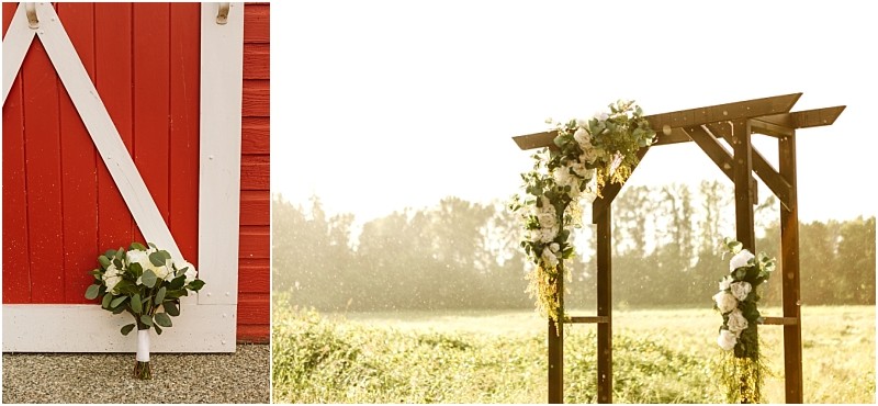 Snohomish & seattle wedding photographer | gsquared weddings photography a bridal bouquet leans against a red barn door on the left while on the right a wooden wedding arch with white flowers and greenery stands in a sunny outdoor field at this marionfield farm elopement | wedding photo by gsquared weddings