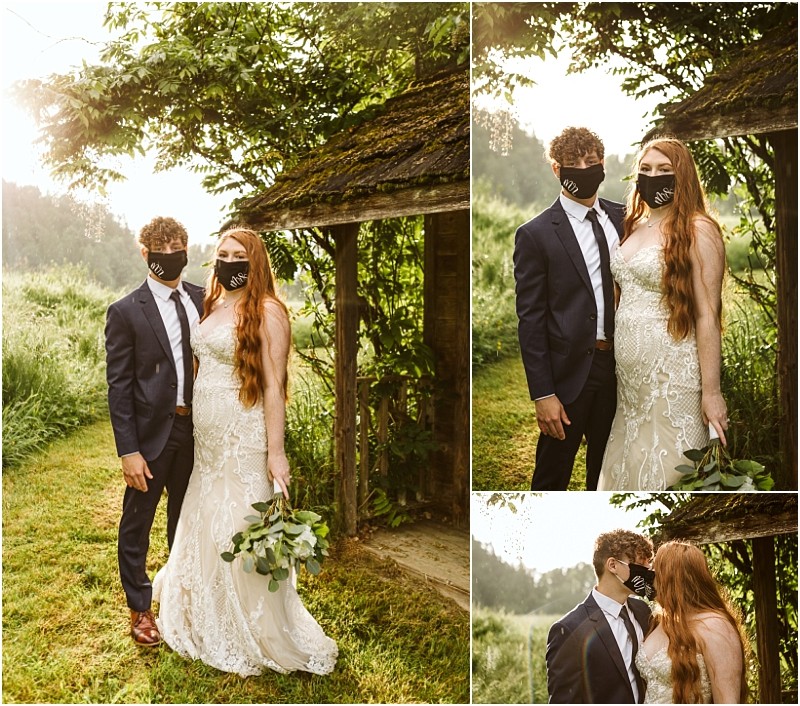 Snohomish & seattle wedding photographer | gsquared weddings photography a bride and groom wearing face masks pose together outdoors under a rustic wooden arbor at their marionfield farm elopement surrounded by greenery The bride wears a white lace gown and holds a bouquet while the groom wears a navy suit | wedding photo by gsquared weddings