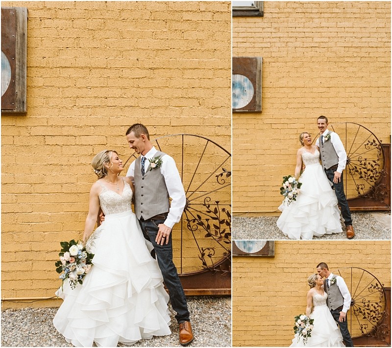Snohomish & seattle wedding photographer | gsquared weddings photography a bride in a white gown and a groom in a vest and jeans stand smiling and embracing in front of a yellow brick wall holding a bouquet and looking happy on their methow elopement wedding day | wedding photo by gsquared weddings