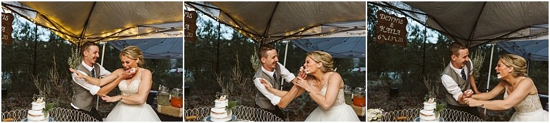 Snohomish & seattle wedding photographer | gsquared weddings photography a bride and groom laugh and playfully feed each other cake under a tent at their methow elopement smiling and enjoying the moment together | wedding photo by gsquared weddings