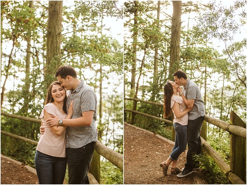 Snohomish & seattle wedding photographer | gsquared weddings photography a young couple poses affectionately on a wooded trail during their deception pass engagement session In the first image they smile and embrace in the second they share a kiss surrounded by trees and wooden fencing in june 2020 | wedding photo by gsquared weddings