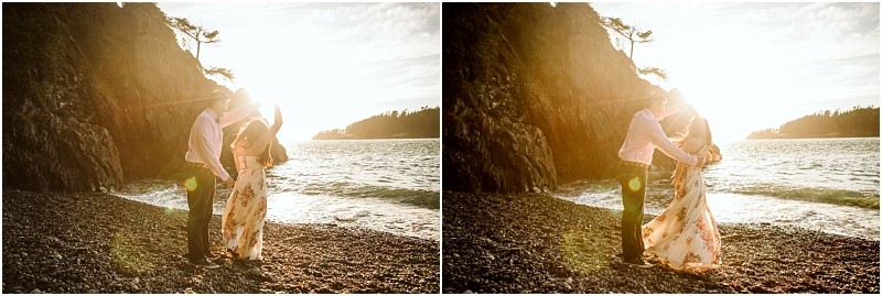 Snohomish & seattle wedding photographer | gsquared weddings photography a couple stands on a rocky beach at sunset during their deception pass engagement session in june 2020 embracing and smiling as sunlight streams around them with waves rolling in the background | wedding photo by gsquared weddings