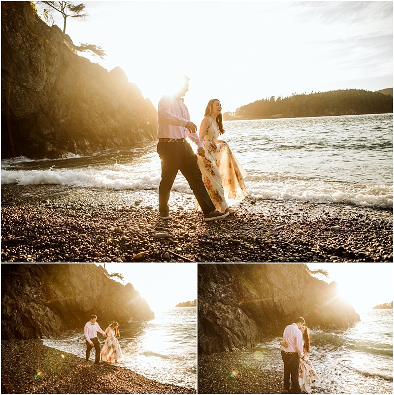 Snohomish & seattle wedding photographer | gsquared weddings photography a couple walks along a rocky beach at sunset during their deception pass engagement session in june 2020 The woman in a floral dress and the man in a white shirt are framed by crashing waves and golden sunlight | wedding photo by gsquared weddings