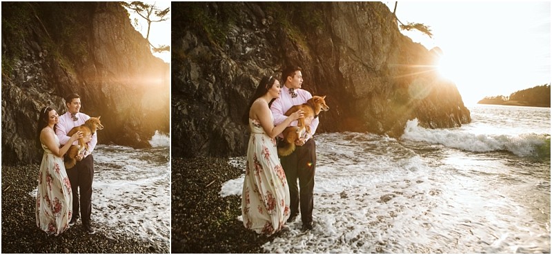Snohomish & seattle wedding photographer | gsquared weddings photography a couple stands on a rocky beach at sunset during their deception pass engagement session in june 2020 holding a small brown dog Waves crash nearby and sunlight streams over a cliff as they enjoy this special moment together | wedding photo by gsquared weddings