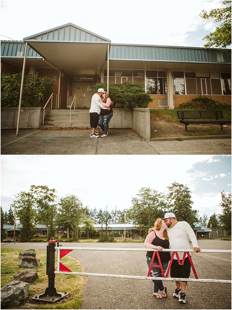 Snohomish & seattle wedding photographer | gsquared weddings photography a couple embraces and kisses outside a building with a blue roof during their gray bridge engagement then stands together by a red and white barrier gate in front of the same building | wedding photo by gsquared weddings