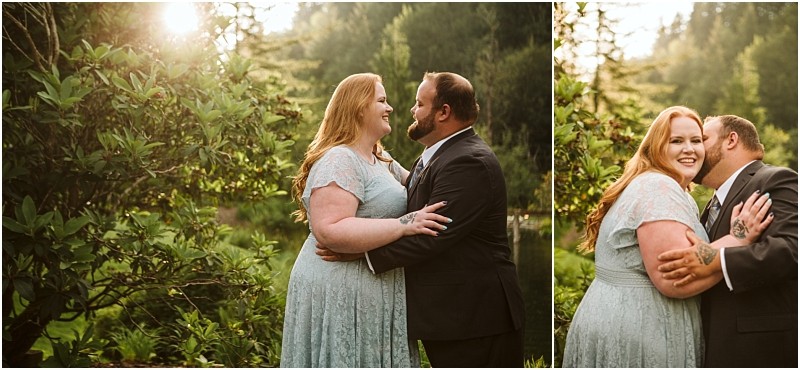 Snohomish & seattle wedding photographer | gsquared weddings photography a couple dressed formally stands outdoors in a lush green garden at sunset during their gray bridge engagement smiling and embracing each other warmly amid golden sunlight and towering trees | wedding photo by gsquared weddings