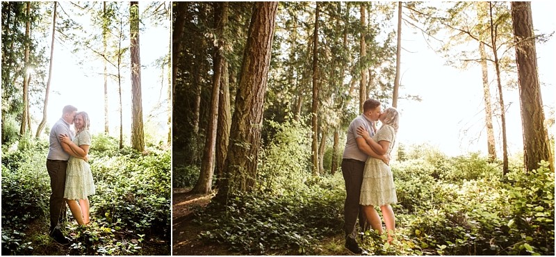 Snohomish & seattle wedding photographer | gsquared weddings photography a couple stands embracing and kissing in a sunlit forest at deception pass whidbey island surrounded by tall trees and green foliage Their dogs wander nearby as warm light filters through the trees creating a romantic atmosphere | wedding photo by gsquared weddings
