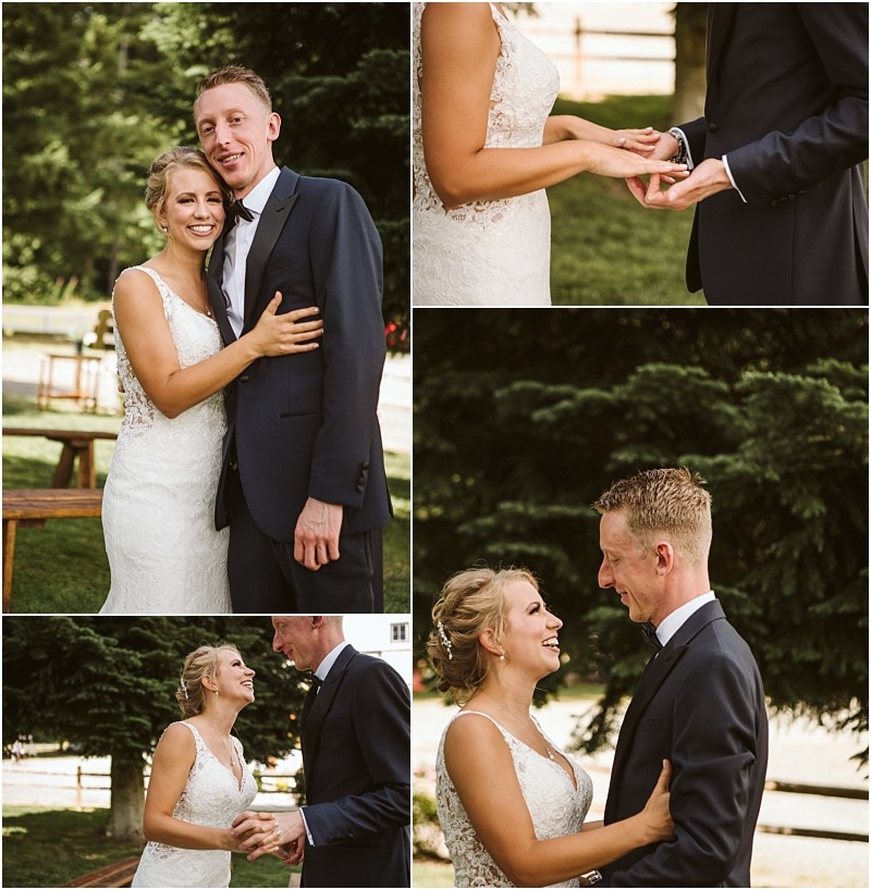 Snohomish & seattle wedding photographer | gsquared weddings photography a bride and groom dressed in a white wedding gown and dark suit smile exchange rings and embrace outdoors at a summer barn at holly farm wedding surrounded by greenery and trees on a sunny day | wedding photo by gsquared weddings
