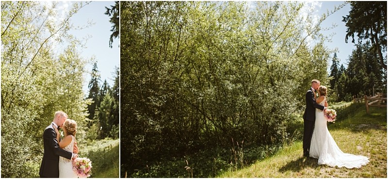 A bride and groom stand outdoors in a sunlit green wooded snohomish area embracing each other and holding a bouquet with bright blue sky and trees in the background Snohomish wedding photography