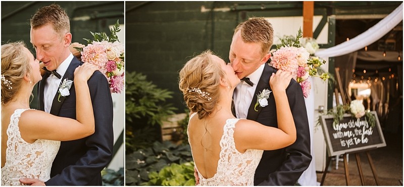 A bride and groom embrace and smile at each other outdoors in snohomish The bride holds a bouquet of pink and white flowers Wedding decorations and a chalkboard sign are visible by the white tent entrance in the background Snohomish wedding photography