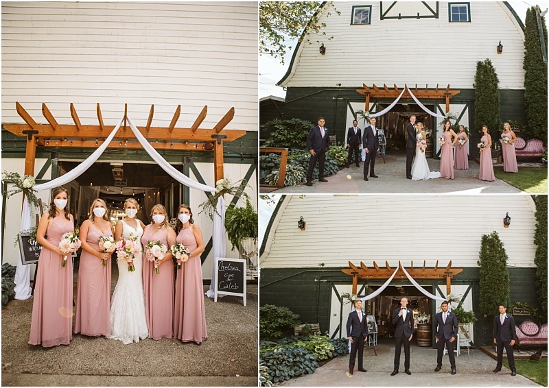 A wedding party poses outside a rustic snohomish barn The bride and bridesmaids wear pink dresses bridesmaids wear masks Groomsmen in suits stand together White drapery and flowers decorate the barn entrance Snohomish wedding photography