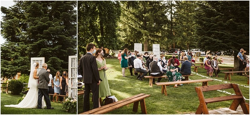 An outdoor snohomish wedding scene with guests seated on wooden benches on a lawn surrounded by tall trees On the left a couple stands with an officiant near white doors as guests socialize and wait for the ceremony to begin Snohomish wedding photography
