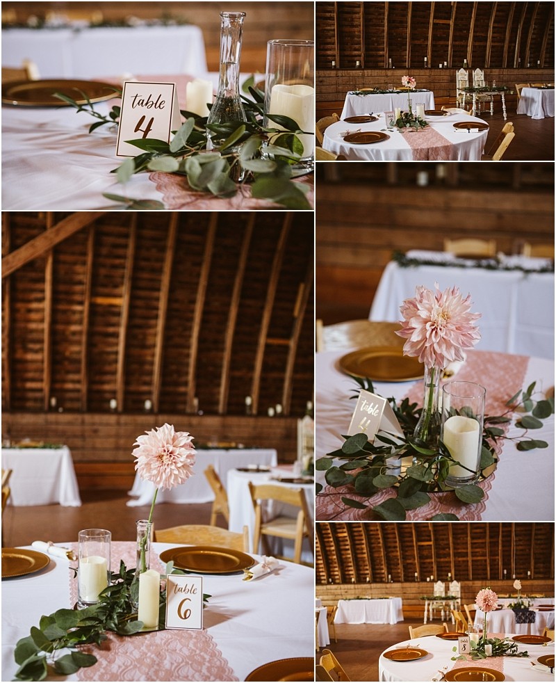 Wedding reception tables in snohomish feature pink floral centerpieces greenery candles and numbered cards in a rustic venue with wooden walls and arched ceiling Round tables are adorned with pink runners and elegant gold plates Snohomish wedding photography