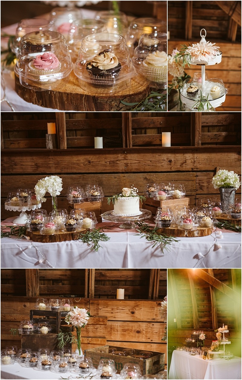 A rustic dessert table in a snohomish barn set with cupcakes in clear domes a white cake with a topper floral arrangements and candlesall atop white tablecloths for a charming countryside celebration Snohomish wedding photography